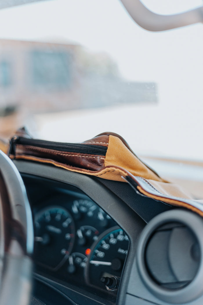 Beesdam custom-fit dash cover fitted over a vehicle dashboard