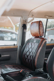 Beesdam Legacy Pro seat cover in charcoal canvas with dark brown leather trim fitted in a Toyota Land Cruiser 79